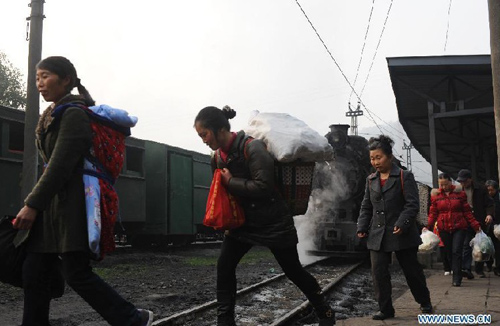Passengers get off Jiayang mini steam engine train in Qianwei County, southwest China's Sichuan Province, March 15, 2012. Built in 1958, Jiayang mini steam engine train with a narrow rail gauge, used to be a coal transportation. Later, added some passengers carriages, it became the major transportation for local villagers living in and around the mountainous Bajiaogou town and Shixi town. As the steam trains disappear in the world, more and more tourists from home and abroad came here to visit the mini steam engine train. Photo: Xinhua