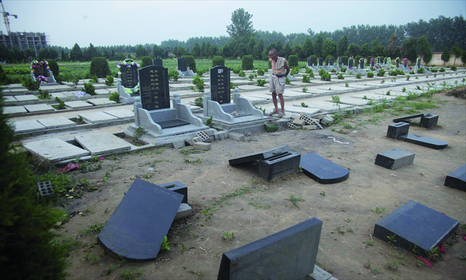 Tombstones are knocked over in a graveyard surrounded by farmland in Shangshui county, Henan Province. The county has started a program to level all tombs in its 28 villages to make way for more farmland. Photo: CFP