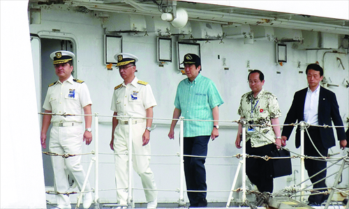 Japanese Prime Minister Shinzo Abe Wednesday (center) inspects a patrol boat of the Japan Coast Guard in the remote Okinawan island of Ishigaki, which is close to the disputed Diaoyu Islands in the East China Sea. Photo: AFP
