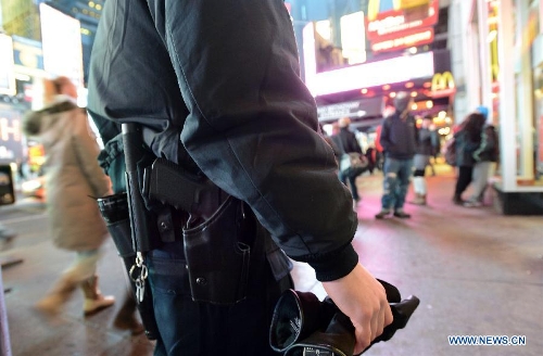 A policeman patrols at the Times Square in New York, the United States, Jan. 16, 2013. New York State Governor Andrew Cuomo on Tuesday signed the NY Safe Act following the Assembly has voted overwhelmingly in favor of the bill, which was seen as the toughest gun control law in the nation and the first since the Newtown school shooting. (Xinhua/Wang Lei)