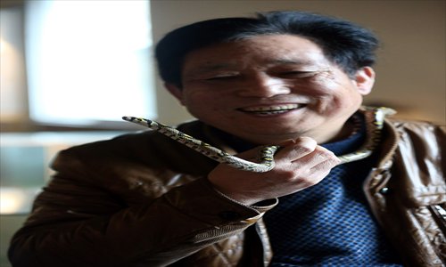 Yang Hongchang hangs out with his favorite snake. Photo: GT/Yang Hui 