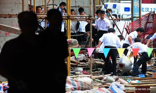 Photo taken on Sept 13, 2012 shows the accident site of a building under construction in central China's Hubei Province. Nine people were killed after a lift crashed from the 30th floor of the building Thursday. Photo: Xinhua 