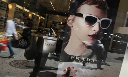An advertisement for Prada eyewear is viewed in a window along Broadway on Friday in New York, New York. In new data released today by the US Commerce Department, it was revealed that US economic growth accelerated to an annual rate of 2.5 percent from January through March. Photo: AFP