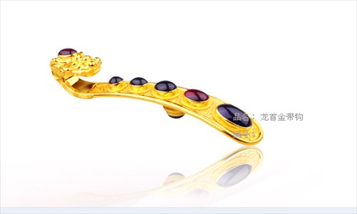 A gem-inlaid gold belt hook with a dragon-head