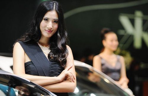 Models pose beside a car during the 15th Chengdu Motor Show (CDMS) in Chengdu city, Southwest China's Sichuan Province, August 31, 2012. The CDMS opens to the public from August 31 to September 9, with the participation of a total of 420 exhibitors from home and abroad. Photo: Xinhua