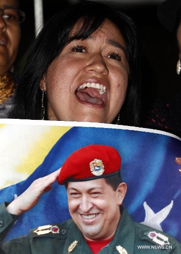 A resident reacts in front of Venezuela's Embassy to Ecuador, after the news of Venezuelan President Hugo Chavez's death was released, in Quito, Ecuador, on March 5, 2013. Venezuelan President Hugo Chavez died on March 5. (Xinhua/Santiago Armas)