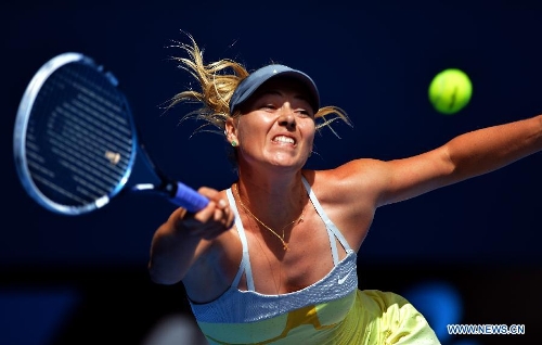 Maria Sharapova of Russia hits a return during the first round women's singles match against her compatriot Olga Puchkova on the first day of 2013 Australian Open tennis tournament in Melbourne, Australia, Jan. 14, 2013. Maria Sharapova won 2-0 to enter the next round. (Xinhua/Chen Xiaowei) 