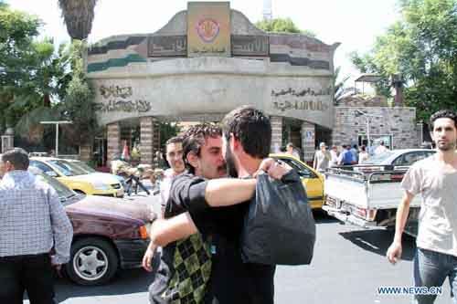 Prisoners are seen outside the headquarters of the Police Command in Damascus, Syria, September 9, 2012. Dozens of prisoners have been released from Syrian jails on Sunday as part of the government's reform program. Syria says those who were released didn't take part in bloody events in the country and their hands were clean from the Syrians' blood. Hundreds of prisoners were released over the past few weeks in different cities and provinces. Photo: Xinhua
