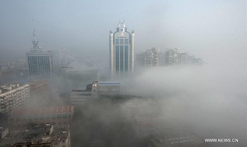 Buildings are seen amid dense fog in Wuhan City, capital of central China's Hubei Province, Jan. 12, 2013. (Xinhua/Cheng Min)&nbsp; 