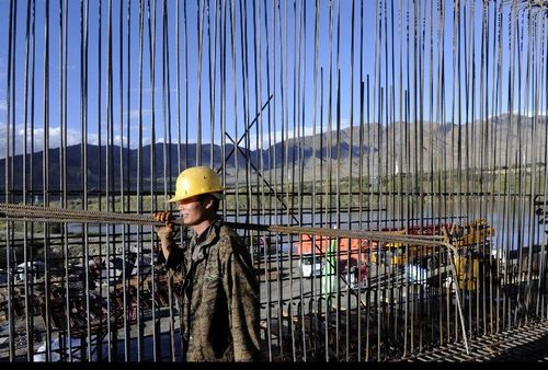 A worker carries materials at the construction site of the railway linking Lhasa and Xigaze in Southwest China's Tibet Autonomous Region, September 21, 2012. The railway runs 253 kilometers with a designed transportation capacity of more than 8.3 million tonnes every year. The construction work started in 2010 and it is estimated to finish in 2014. Photo: Xinhua