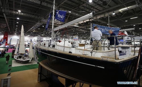 Visitors chat with a seller at the 58th London Boat Show, held at the ExCeL Exhibition and Convention Centre in London, Jan. 14, 2013. The 58th London Boat Show showcases, demonstrates and sells maritime equipments including luxury yachts, dinghies, boating equipment and clothing with interactive sections and features attractions devoted to boating until Jan. 20, 2013. (Xinhua/Wang Lili) 