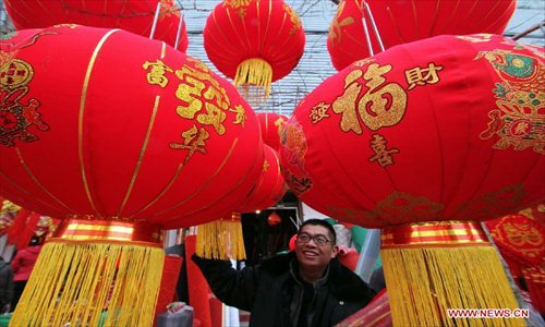 A man selects red lanterns for the coming Spring Festival in Linyi City, east China's Shandong Province, Feb. 8, 2013. The Spring Festival, the most important occasion for the family reunion for the Chinese people, falls on the first day of the first month of the traditional Chinese lunar calendar, or Feb. 10 this year. Photo: Xinhua