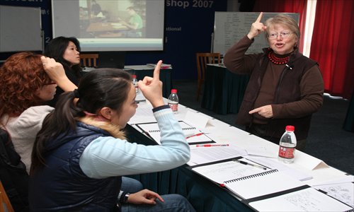 Patricia Decaro from the US teaches sign language in Shanghai in a workshop organized by the Shanghai Disabled Persons' Federation. Photo: CFP