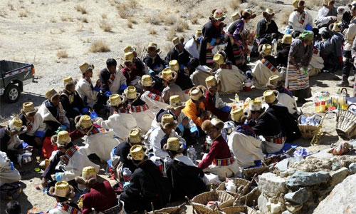 People gather to celebrate Losar, the New Year's Day in the Tibetan calendar, at Caina Village of Qushui County in Lhasa, capital of southwest China's Tibet Autonomous Region, Feb. 11, 2013. People of the Tibetan ethnic group embraced the 