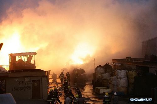 Firefighters hose down fire at a workshop in Zhenhai District of Ningbo, East China's Zhejiang Province, August 1, 2012. The fire broke out in a renewable resources plant in Ningbo at about 5 pm Wednesday, leave one person dead and 18 others injured. The investigation of the reason of the fire is underway. Photo: Xinhua
