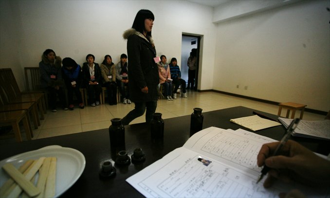 Young women applying for military service wait to receive medical examination in Taizhou, Jiangsu Province on November 14, 2012. Photo: CFP