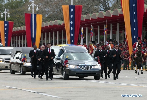 The body of late Venezuelan President Hugo Chavez is carried from the Military Academy to the Mountain Barracks, in the city of Caracas, capital of Venezuela, on March 15, 2013. Venezuelans honored late President Hugo Chavez, before his remains were transfered to the Mountain Barracks, where he will rest inside a glass case. Venezuelan President died on March 5, after struggling with cancer for two years. (Xinhua/AVN) 