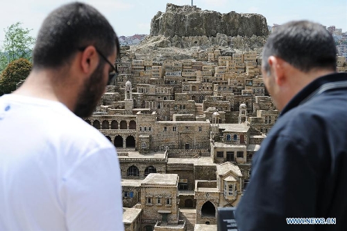 Visitors look at the miniature of traditional Stone Houses in Mardin, in the Miniature park in Istanbul, Turkey, on May 11, 2013. The Miniaturk park is the first miniature park in Istanbul and has welcomed 6.5 million visitors over the past 10 years. (Xinhua/Lu Zhe) 