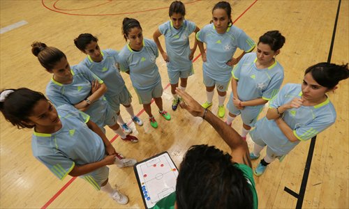 Players of the Stars Academy for Sports (SAS) futsal team receive instructions during a training session on November 27. Photos: CFP