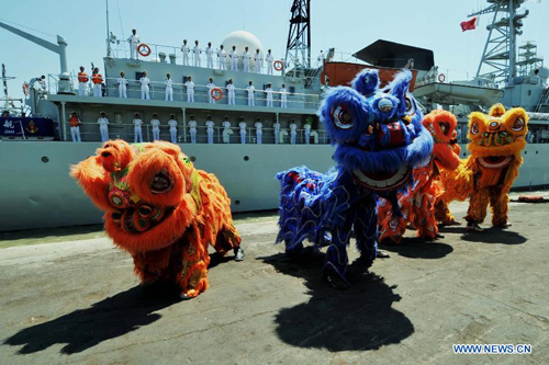 Lion dance is performed to welcome the arrival of the Chinese Navy training vessel 