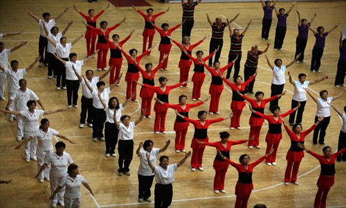 Some 60 residents and 80 deaf and mute people from Huangpu district compete during the inauguration of the district's First Paralympics Games Tuesday at Luwan Stadium. Photo: Cai Xianmin/GT