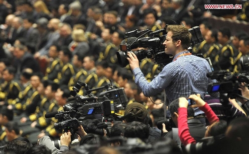A journalist works at the closing meeting of the first session of the 12th National People's Congress (NPC) at the Great Hall of the People in Beijing, capital of China, March 17, 2013. (Xinhua/Wang Peng)