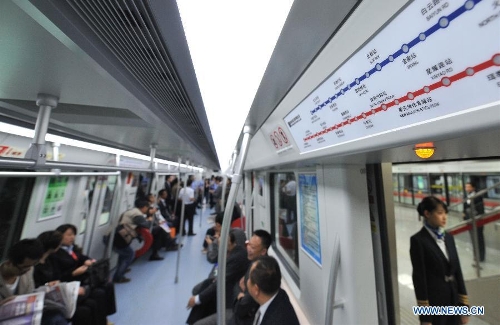 Citizens take a train of the newly-opened subway line in Kunming, capital of southwest China's Yunnan Province, May 20, 2013. The southern part of the first phase of Kunming subway line 1 and line 2 opened for trial operation on Monday. It's China's first plateau subway. (Xinhua/Lin Yiguang)