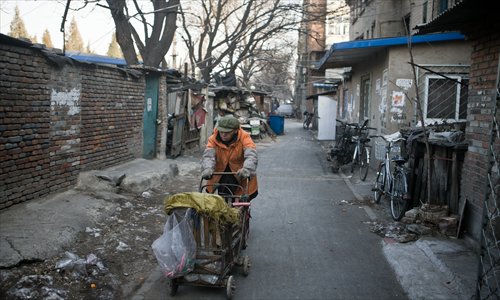 A resident walks in the alley at Yongdingmen Dongli, which is slated for demolition, in Dongcheng district on Wednesday afternoon. Photo: Li Hao/GT 