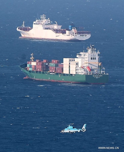 An Israeli military naval ship and an Israeli air force helicopter operate next to a cruise ship off the coast of Haifa, northern Israel, Thursday, April 25, 2013. An Israeli Air Force F-16 fighter jet downed a drone off the coastline of the northern city of Haifa at noon of Thursday, the Israeli Defense Forces (IDF) said. (Xinhua/Jini) 