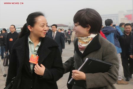 Tai Lihua (L), a member of the 12th National Committee of the Chinese People's Political Consultative Conference (CPPCC), arrives at the Tian'anmen Square to attend the second plenary meeting of the first session of the 12th CPPCC National Committee in Beijing, capital of China, March 7, 2013. Women's presence in China's politics has been increasing in recent decades. The number of female deputies to the 12th National People's Congress and members of the 12th National Committee of the Chinese People's Political Consultative Conference (CPPCC) rise to 699 and 399, reaching 23.4% and 18.4% of the total respectively. (Xinhua/Xing Guangli) 