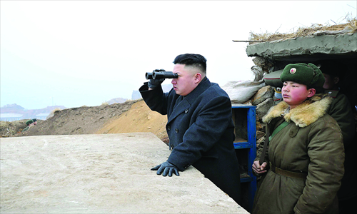 North Korean leader Kim Jong-un looks out to the south as he inspects Jangjae Islet Defense Detachment near North Korea's southwestern sector of the front on Thursday. Photo: AFP / KCNA via KNS