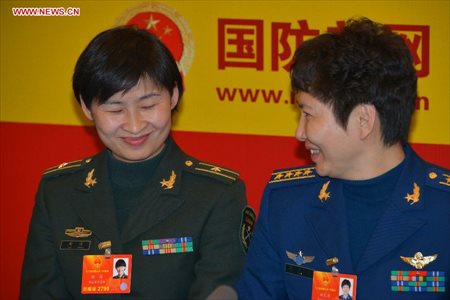 Chinese astronaut Liu Yang (L), a deputy to the 12th National People's Congress, reacts during an interview by Xinhua in Beijing, capital of China, March 7, 2013. Women's presence in China's politics has been increasing in recent decades. The number of female deputies to the 12th National People's Congress and members of the 12th National Committee of the Chinese People's Political Consultative Conference (CPPCC) rise to 699 and 399, reaching 23.4% and 18.4% of the total respectively. (Xinhua/Li Gang) 