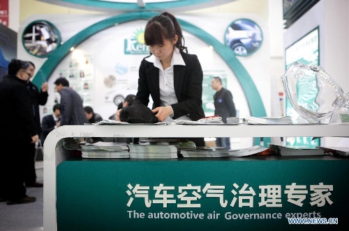An exhibitor on products removing air pollution inside vehicles works at the 16th China International Expo for Auto Electronics, Accessories, Tuning & Car Care Products (CIAACE 2013) in Beijing, capital of China, March 3, 2013. The four-day CIAACE 2013 kicked off on March 1 in Beijing. (Xinhua/Zheng Huansong)&nbsp; 