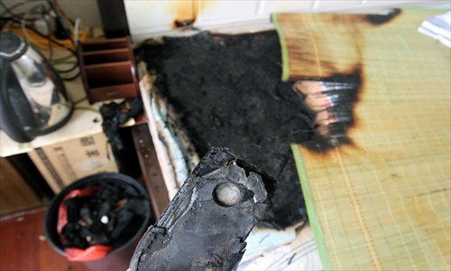 All that is left of consumer Wang Kai's iPhone 4 is shown after the Apple gadget exploded on July 9 in Chongqing. He was asleep when the phone spontaneously combusted and burnt his mat. The incident may have been caused by faulty components, local police said. Photo: CFP