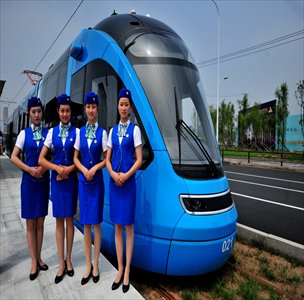 Four tram attendants stand in front of a carriage on Tuesday in Shenyang, Liaoning Province. The newly-completed tram system will start operation on August 15. Photo: CFP
