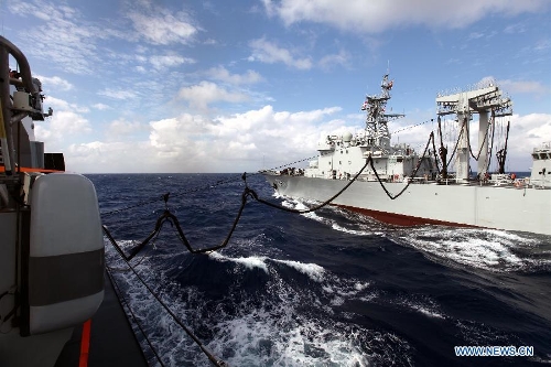 &nbsp;Supply ship Weishanhu (R) tranport fuel and other materials to Missile destroyer Harbin at the South China Sea, Feb. 20, 2013. The supply ship Weishanhu reinforced the missile destroyer Harbin and the frigate Mianyang on Wednesday with fuel, fresh water and other materials. The 14th naval squad, sent by the Chinese People's Liberation Army (PLA) Navy, departed Saturday from China to the Gulf of Aden and Somali waters for escort missions. The fleet comprises three ships -- the missile destroyer Harbin, the frigate Mianyang and the supply ship Weishanhu -- carrying two helicopters and a 730-strong troop. (Xinhua/Rao Rao) 