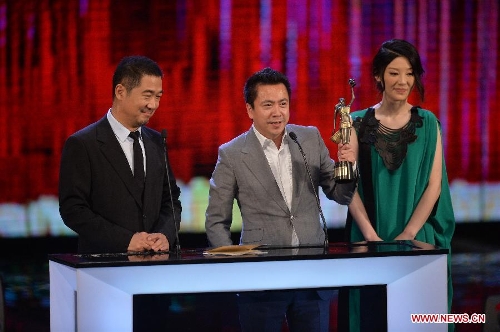 Actor Zhang Guoli (1st L), producer Wang Zhonglei (C) and actress Xu Fan receives the Best Film from Mainland and Taiwan award for their movie 