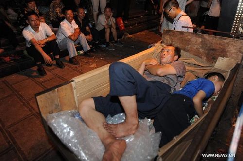People rest on a tricycle at quake-hit Luozehe Town, Yiliang County, Southwest China's Yunnan Province, September 8, 2012. Sixty-seven people have been confirmed dead and 731 others were injured after multiple earthquakes struck a mountainous region in southwest China's Yunnan Province on Friday, the province's civil affairs department said. Photo: Xinhua