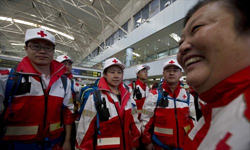 Zhao Baige (right), executive vice president of the Red Cross Society of China, talks to a 17-member disaster relief advance team departing for the Philippines at the Beijing Capital International Airport on  Wednesday. Photo: IC