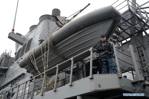 Fire Controlman 2nd Class Swartz stands guard on the deck of the U.S. Navy guided-missile cruiser USS Lake Champlain during a media presentation in North Vancouver, Canada, on April 27, 2013. Approximately 1,000 Canadian and American sailors are in Vancouver to meet the public and media to bring the Navy to the Canadians. (Xinhua/Sergei Bachlakov) 