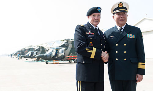 Dempsey (left) poses for a photo with a senior officer of the PLA navy.
