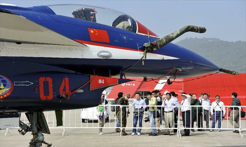 Visitors view the J-10 Fighter of China Air Force during the opening ceremony of the 9th China International Aviation and Aerospace Exhibition in Zhuhai, south China's Guangdong Province, Nov. 13, 2012. About 650 exhibitors in the aviation and aerospace field took part in the six-day event. Photo: Xinhua