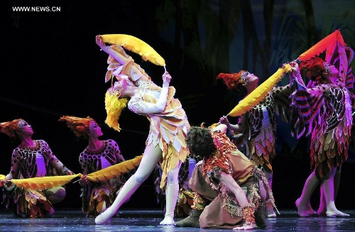 Dancers perform in the rehearsal of the musical Hundred-bird Dress in Nanning, capital of south China's Guangxi Zhuang Autonomous Region, April 27, 2013. The musical tells a legend of the Zhuang ethnic group about a young hero's sacrifice in protecting the homeland against an evil polluting power. (Xinhua/Liu Jun) 