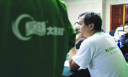 Huang Ming, chairman of Himin Solar, holds a press conference, questioning subsidies offered in the sector, on October 16 in Beijing.