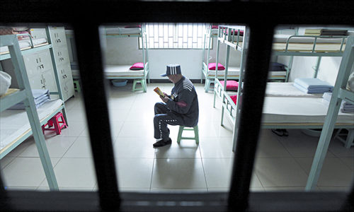 An inmate reads a book in his cell in a prison in Yuzhou, Henan Province. Photo: CFP