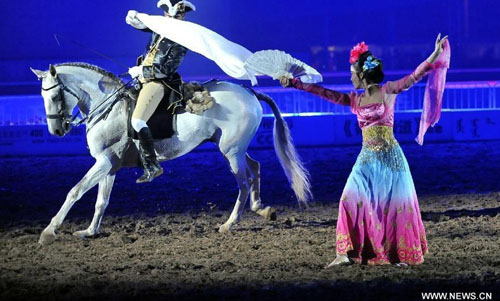 A horseman stages an equestrian performance at the opening ceremony of the second Ordos Dalate International Horse Culture Festival in Dalate Banner of Ordos, north China's Inner Mongolia Autonomous Region, August 25, 2012. Some 60 horsemen from 15 countries and regions gave performances at the festival's opening ceremony Saturday night. Photo: Xinhua