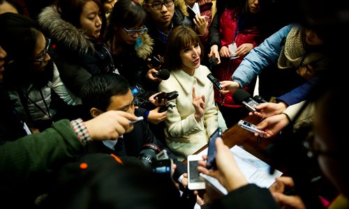 Kim Lee (center) is surrounded by a media scrum after her final divorce hearing from ex-husband Li Yang at Beijing Chaoyang District Court on February 3. Photo: Li Hao/GT 
