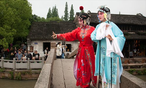 Two Chinese opera performers staging at one bridge of Wuzhen during the Outdoor Carnival of the Wuzhen Theatre Festival. Photo: Courtesy of the festival 