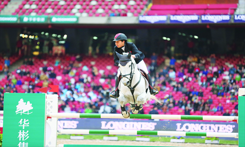 One of this year's Longines Equestrian Beijing Masters competitors, Zhu Meimei, sails over the bar. Photo: Courtesy of Dashing Equestrian