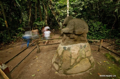 People visit the San Agustin Archaeological Park, in Huila, Colombia, on March 31, 2013. San Agustin Archaeological Park is located in the southern Colombian Department of Huila, which will celebrate its centenary and being denominated as World Cultural Heritage in 1995 by United Nations Educational, Scientific and Cultural Organization (UNESCO) this year. (Xinhua/Jhon Paz)